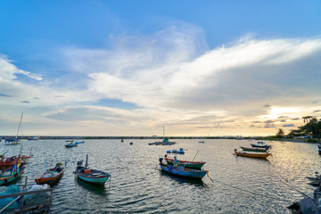 Naklejka na ściany i meble Landscape of view the fishing harbor Sunset Latinos There is a boat landing. In a fishing village in Rayong, Thailand, fishing is the main occupation of the people.