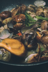 Cooked mussels in white plate.