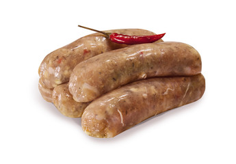 Raw sausages with herbs and hot red pepper on white isolated background