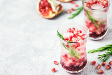 Rosemary pomegranate infused water with ice cubes. Selective focus, space for text.