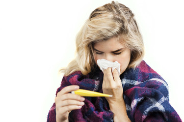 Symptoms of flu or allergies. Strong young European woman with fever, sneezing in a tissue,...