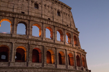 Colosseum, Rome, Italy. The outer wall of the evening coliseum. Arched openings are highlighted in...