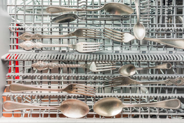 Table forks and spoons in the dishwasher compartment