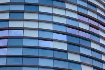 Glass building walls in the rays of sunset as background