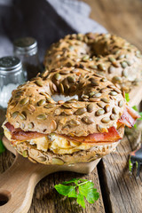 Breakfast bagel with omelet and bacon