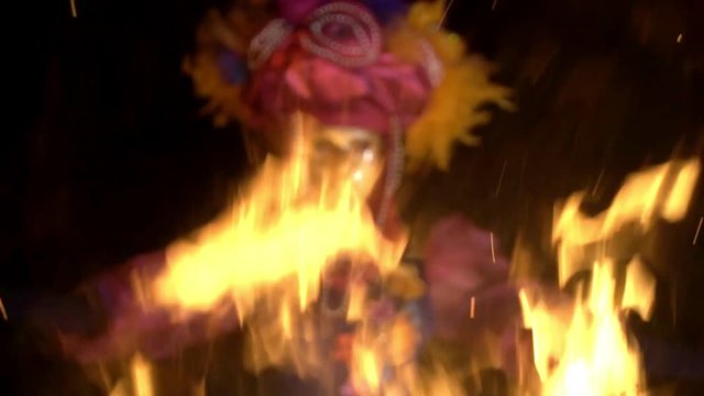 The face of the girl at the masquerade in a Venetian suit hides a mysterious mask. Dance with fire in the night. Concept idea for dance
