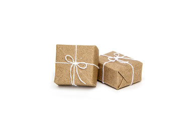 Pile box a parcel or gift wrapped in brown paper and tied with white rope bow tie.  isolated on white background.