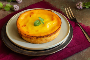 Fresh homemade creamy tart, on rustic dishware, napkin and background.