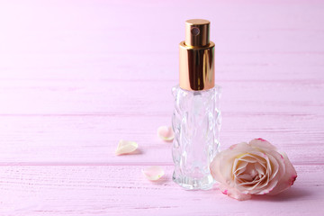 perfume and flowers on a colored background.