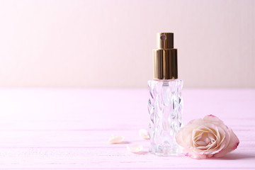 perfume and flowers on a colored background.