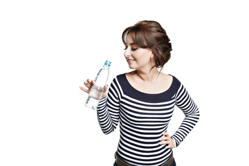 A young woman in a striped tight blouse   holds in his right hand a bottle with clean drinking water.