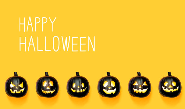 Happy Halloween message with black colored pumpkin lanterns