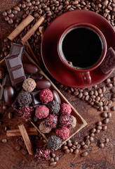 Various chocolates  and cup of black coffee.