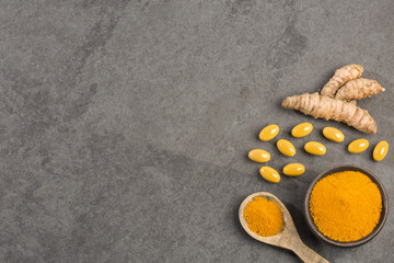 Roots, powder and turmeric pills - Curcuma longa. Top view