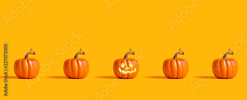 Halloween orange pumpkins on an orange background