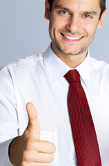 Smiling businessman with thumbs up gesture