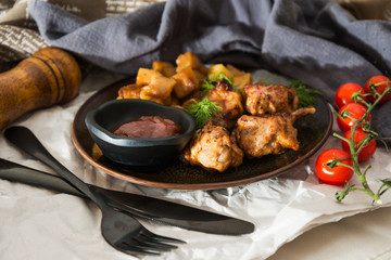 Chicken wings with sauce and golden French fries potatoes