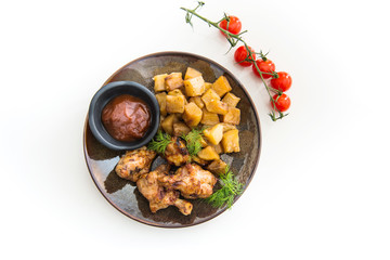 Chicken wings with sauce and golden French fries potatoes