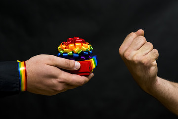 Representative of the LGBT community. Refusal of his proposed holiday gift with symbols. In response, the threat is expressed.