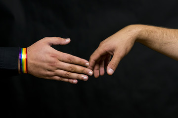 Representative of the LGBT community. Hands reach out for a handshake with a young man.