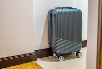 Modern small luggage in hotel room.
