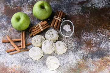 Marshmallow with cinnamon and apple on a concrete background. Top view