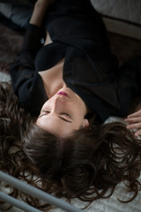 Fototapeta premium Beautiful young girl in sexy lingerie on a bed