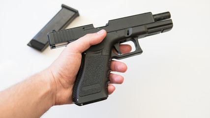 airsoft gun on a white background close-up. .firearms practice concept