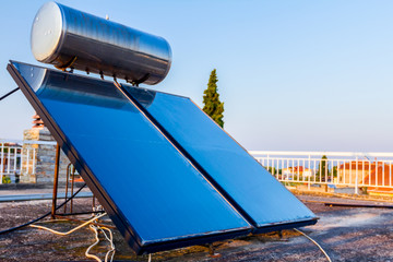 Solar panel, water heater on house roof, green energy
