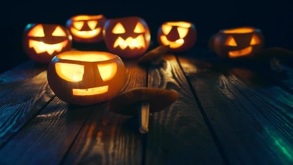 Girl in costume of witch blowing out candles Halloween pumpkins sliding video - Powered by Adobe