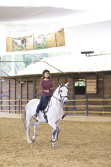 Obraz premium Beautiful Teenager Riding a Horse
