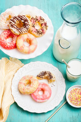 Glazed gluten free donuts with assorted sprinkles and drizzles.