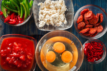 Ingredients for preparing frittata - eggs, sausage chorizo, red