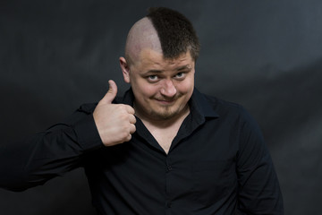 Punk. The hand is raised. Gesture of victory and contentment. On the face a smile.
