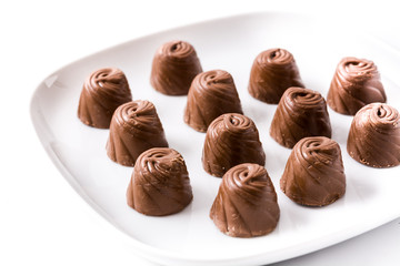 pieces of bonbons on white plate isolated on white background
