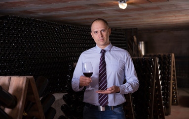 Winemaker offering red wine for tasting