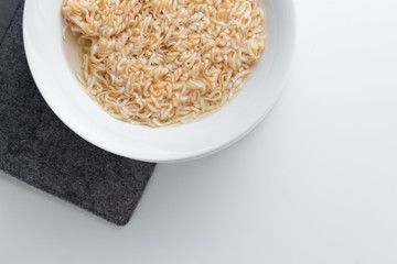 noodle in bowl on white background top view