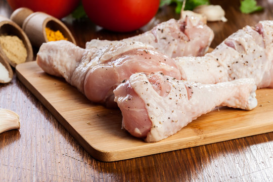 Raw chicken legs with spices