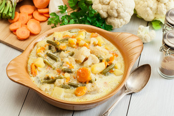 Vegetable soup with ingredients carrot, cauliflower, potato and parsley