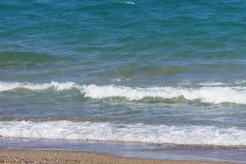 Seashore with a wave on a Sunny day
