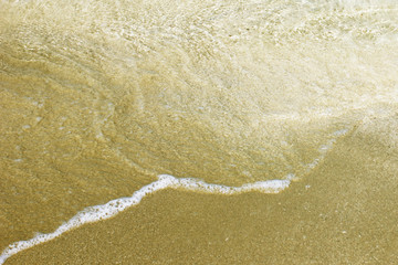 Seashore with a wave on a Sunny day