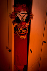 child with monster mask coming out of the closet