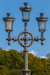 Fototapeta na wymiar Old street lamp in the park against the sky.