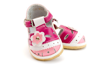 Pink baby shoes isolated on white background.