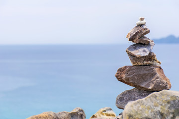 The stones are stacked together,With balance. The background is sea and sky.