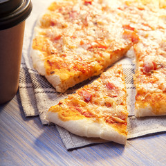 Pizza and Coffee on wooden table, cup of cappuccino.