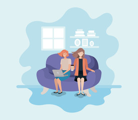 couple of women in living room using technology