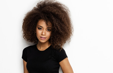 Portrait of young african american woman with afro looking at camera