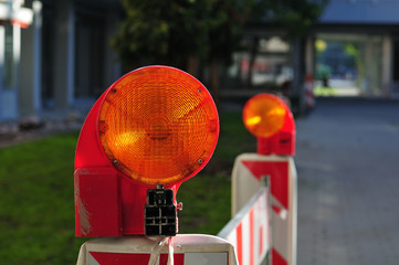 yellow warning lamp at plastic barrier