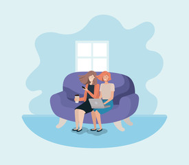 couple of women in living room using technology